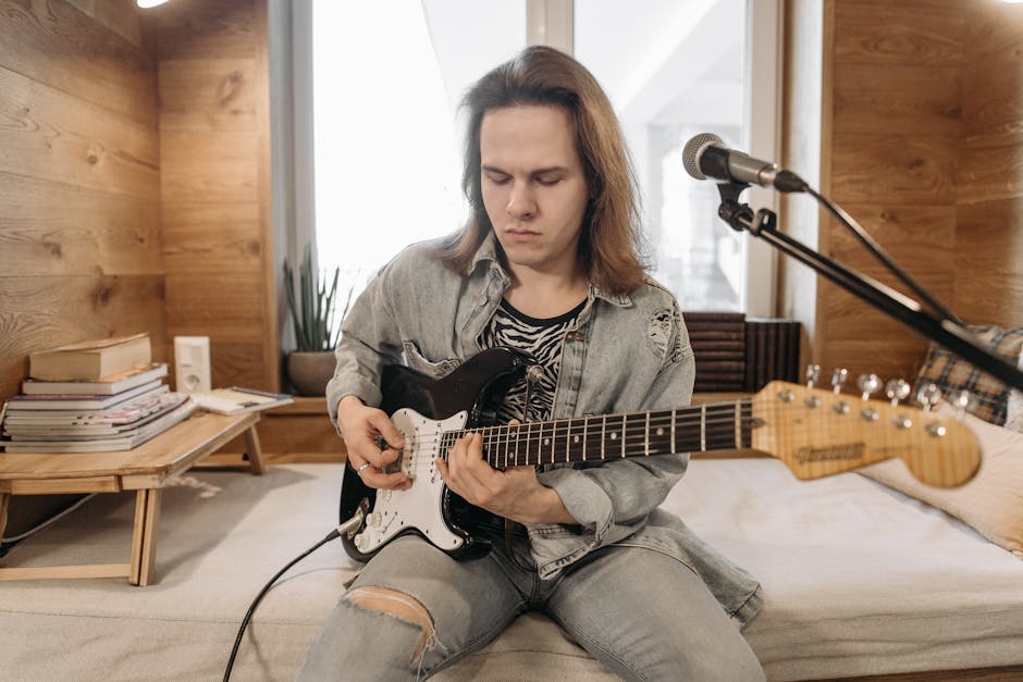 Caucasian adult male playing an electric guitar indoors with focused expression.