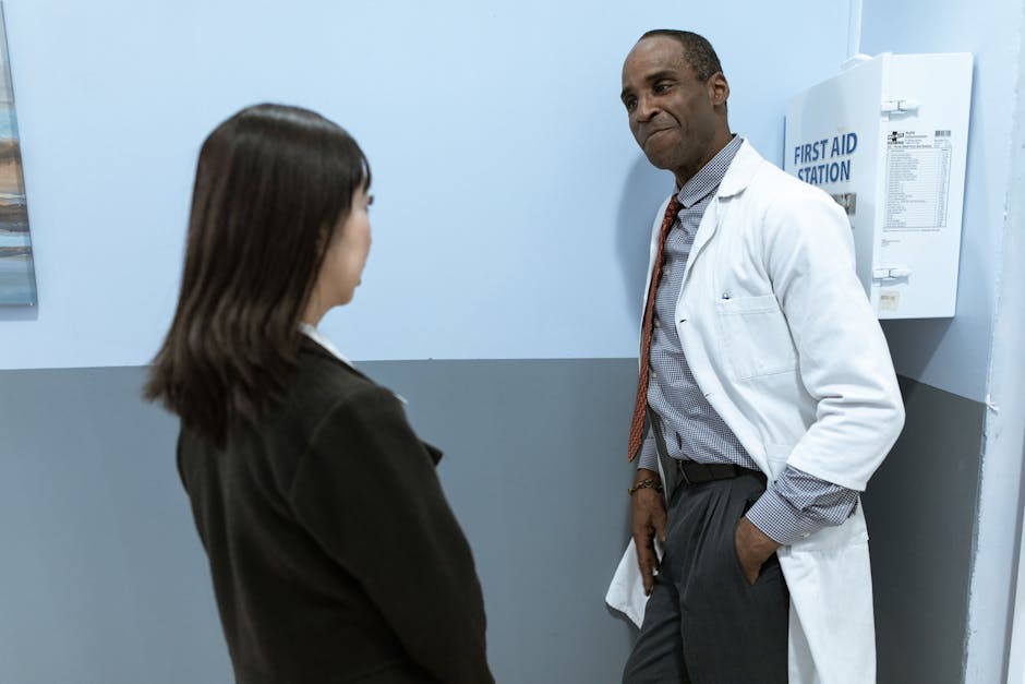 A medical professional converses with a patient in a clinical setting, fostering a comforting environment.