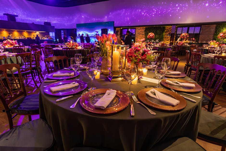 Stunning wedding reception with elegant table settings and floral centerpieces under a glowing ceiling.