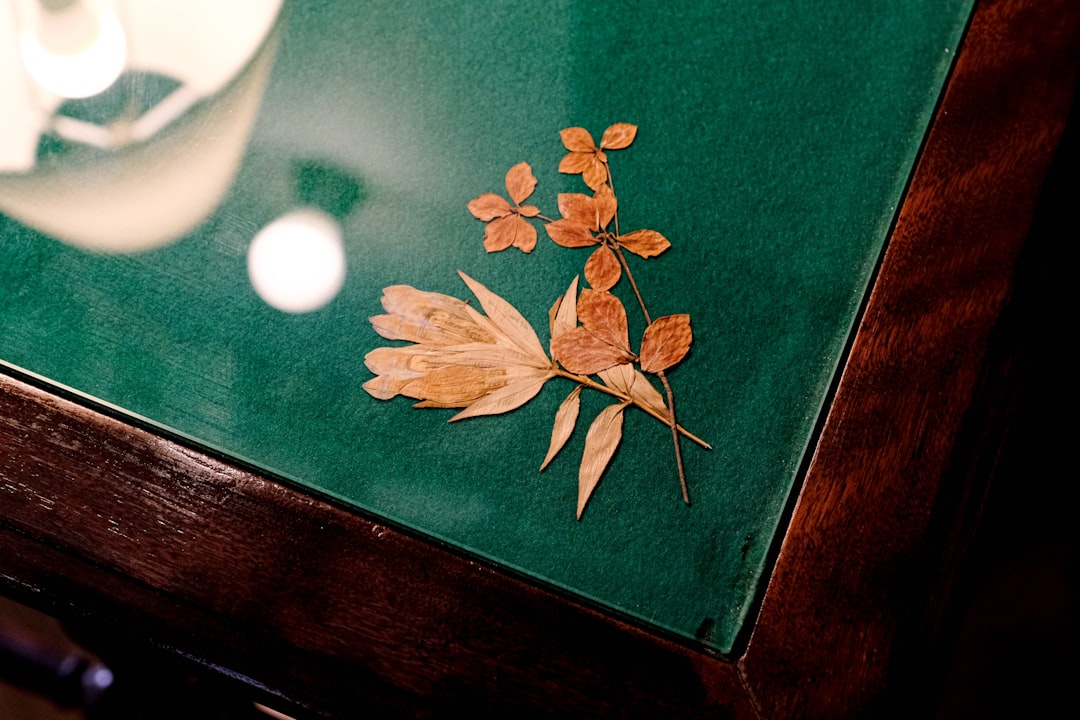 a close up of a table with a vase on it