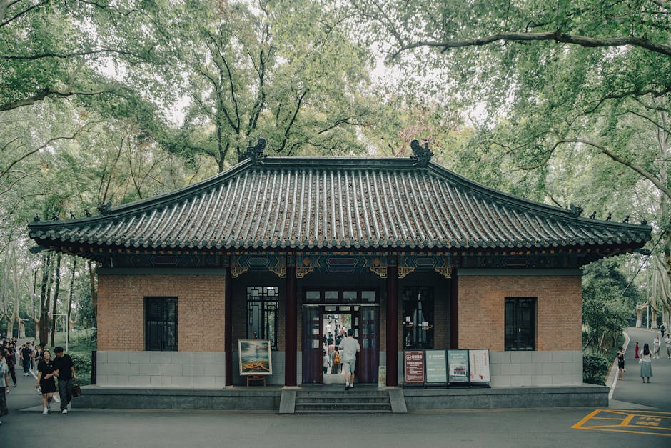 A traditional Chinese building set in lush greenery at Meiling Palace, Nanjing, China.