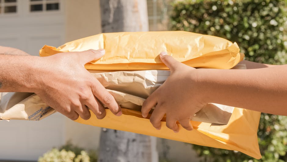 Close-up of two hands exchanging packages, symbolizing delivery and communication.