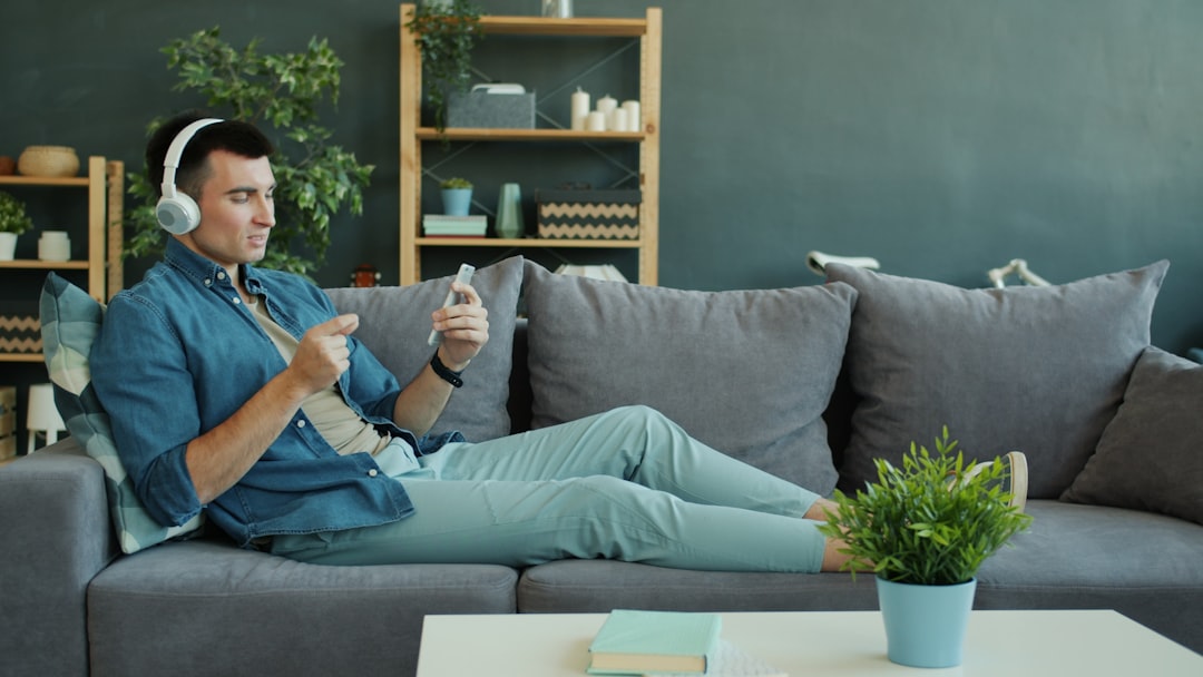 Man wearing headphones relaxing on a couch